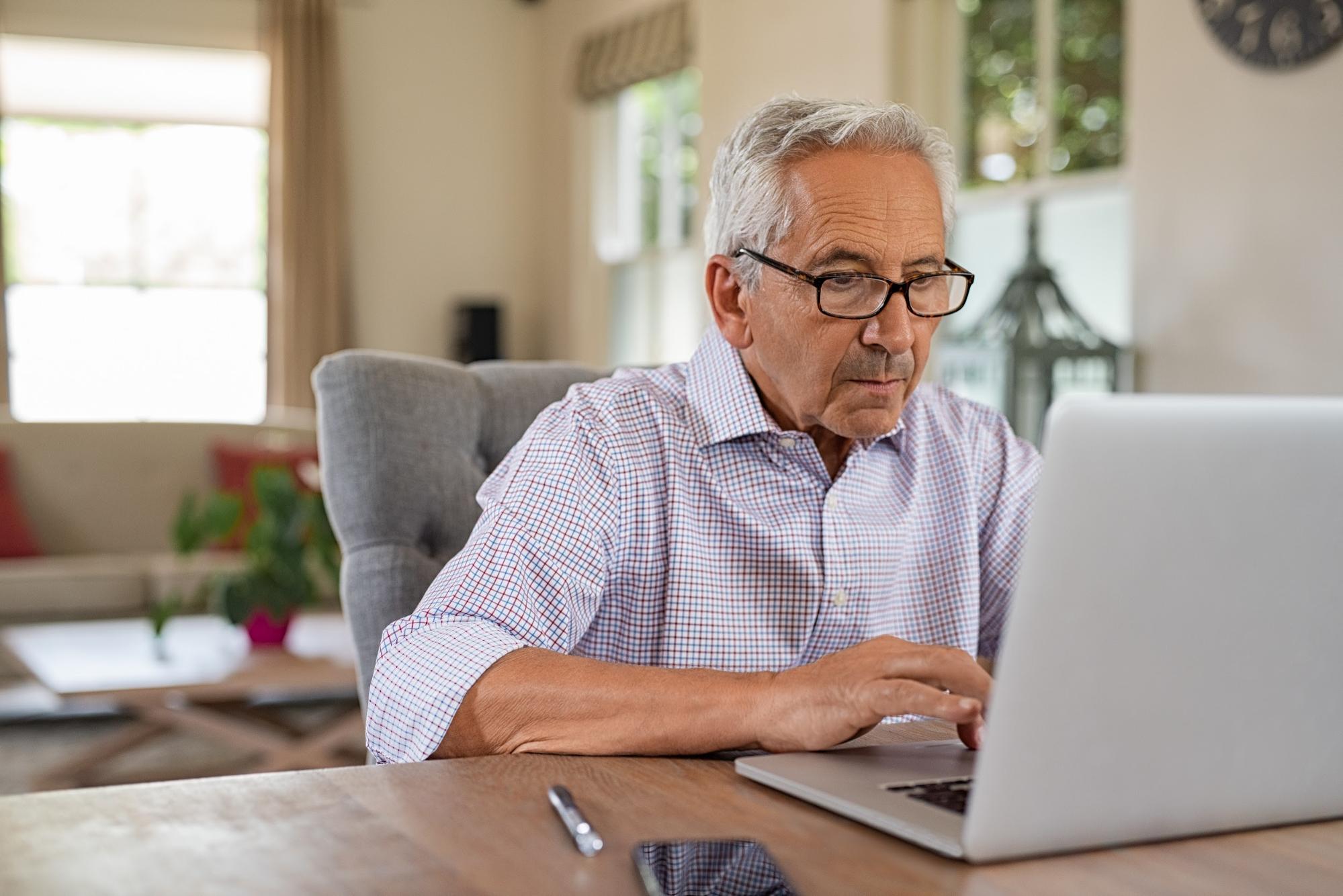 old man using computer